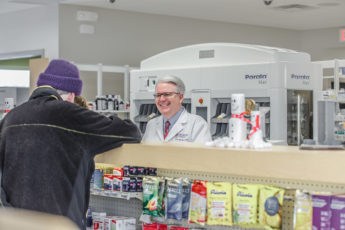 Medicap Pharmacy John talks with customer John Forbes with a customer at Medicap Pharmacy